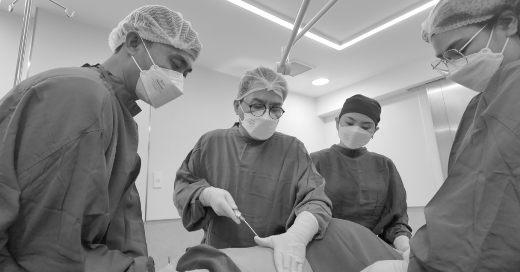 Dr. Cayetano perfoming liposuction surgery